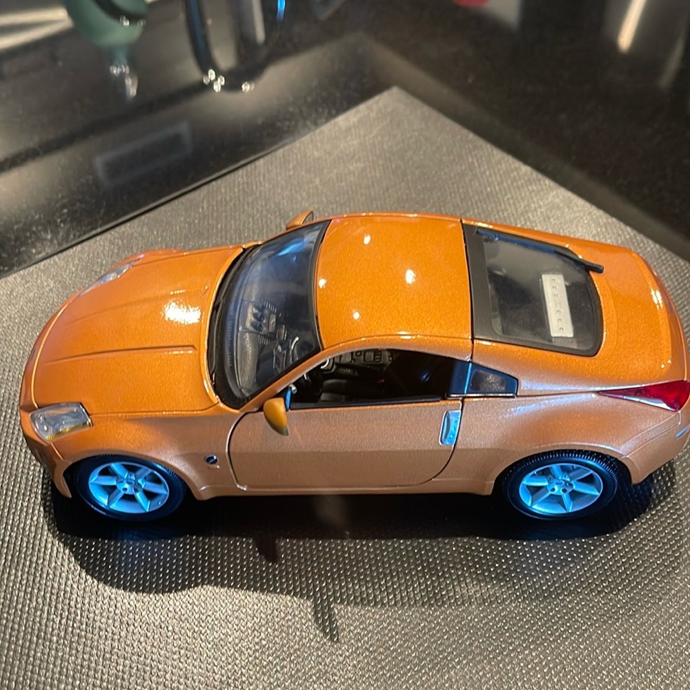 replica of Nissan 350Z burnt orange W/brand new in box table book!
